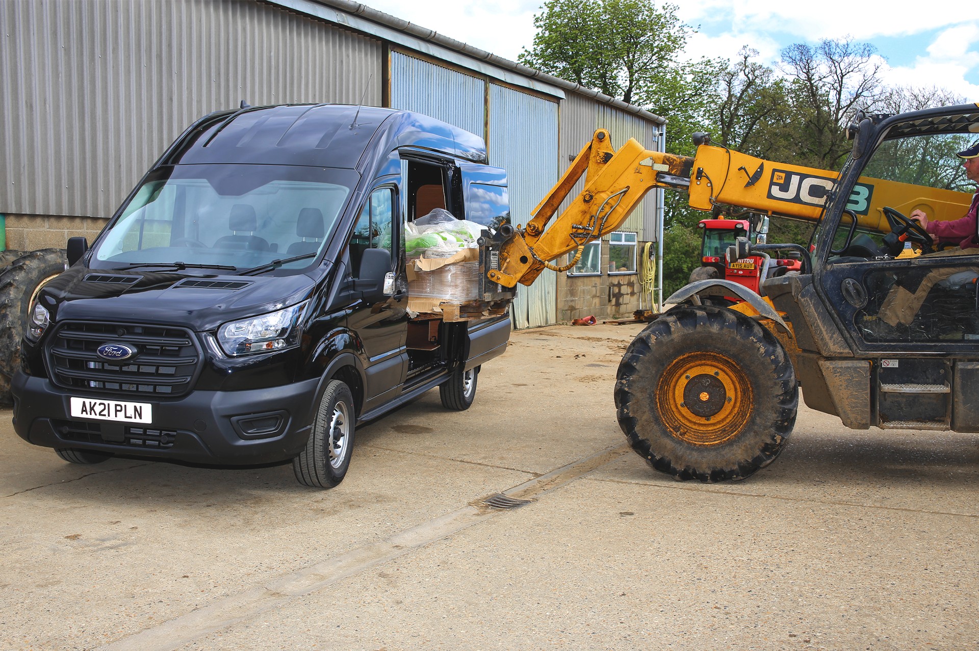 ford transit being loaded by JCB