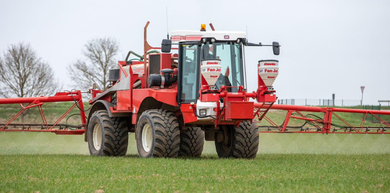 Fan Jet Duo on Bateman sprayer in field.