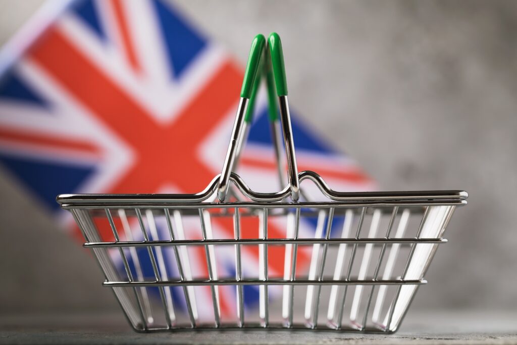 Empty grocery basket on the background of the flag of Great Britain