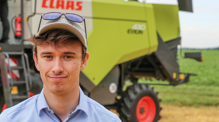 Claas UK combine product specialist, Rob Portman standing in front of Claas Evion combine harvester