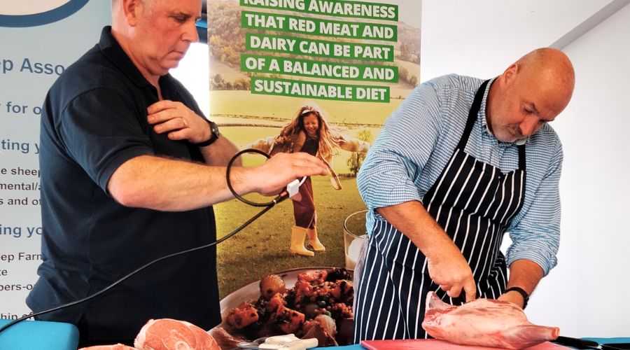 Sheep farming event ran by NSA. Butcher chopping lamb on table.