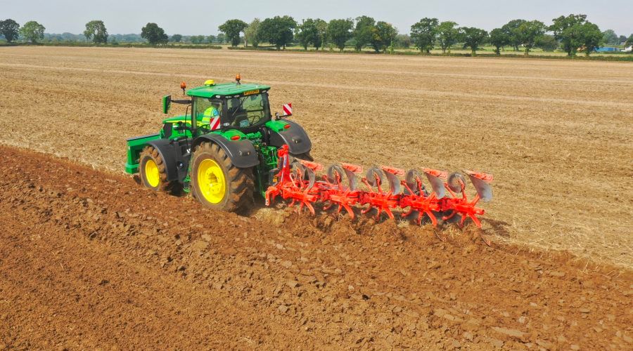 Kuhn cultivation event green tractor red cultivator sunny day