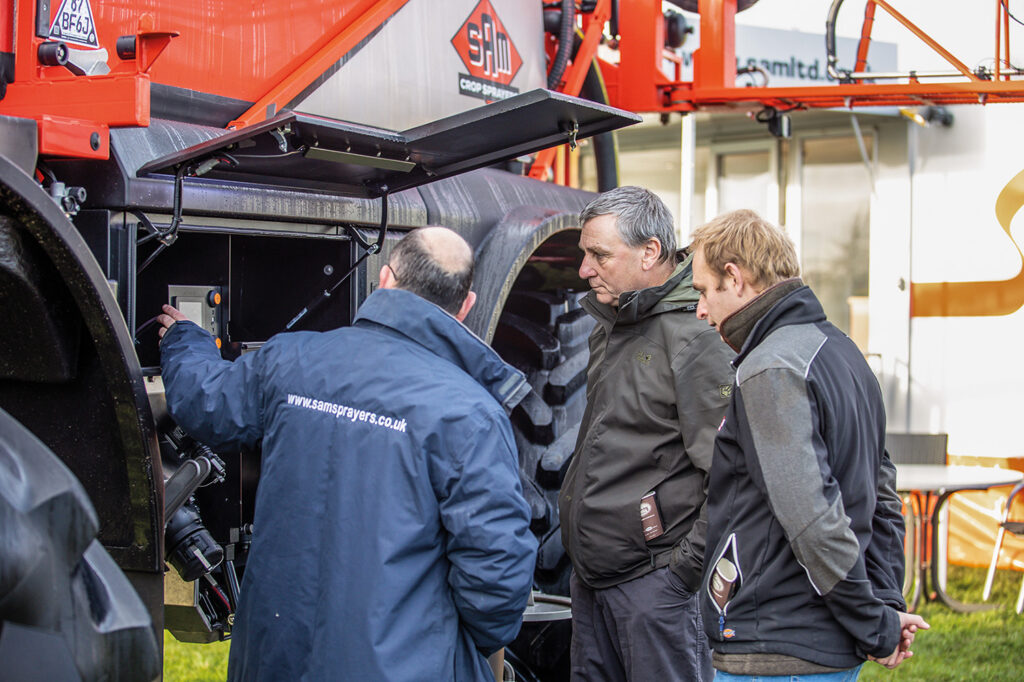 photo of people looking at a machinery exhibit