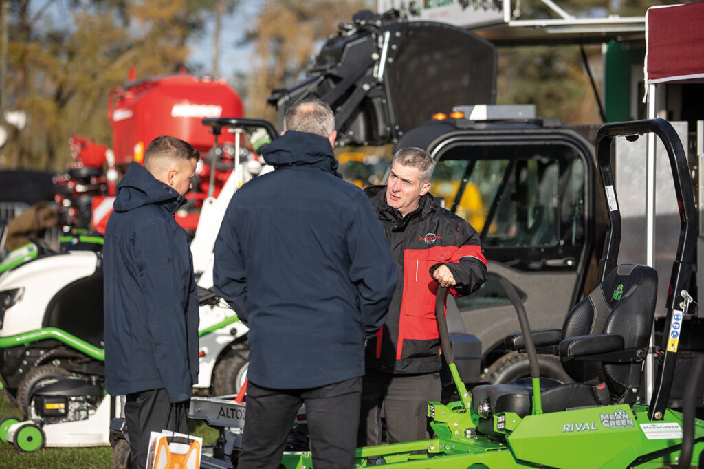 photo of people looking at a machinery exhibit