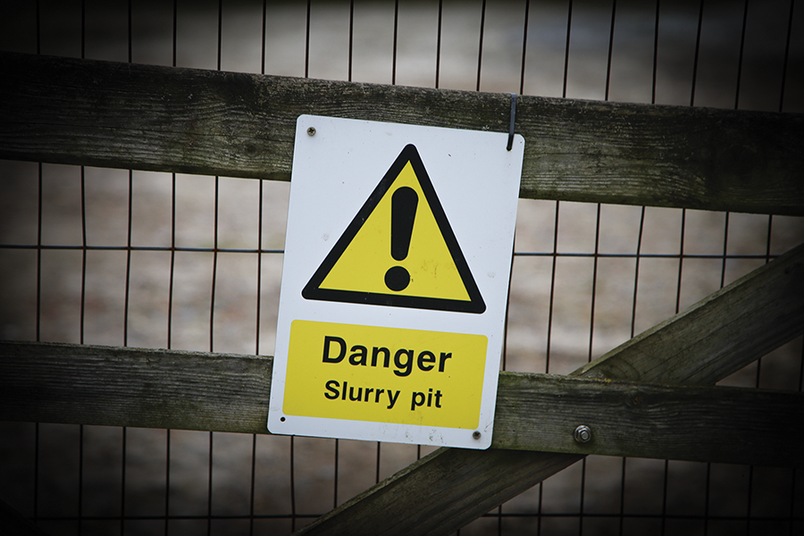 Danger slurry pit hazard sign on slurry article