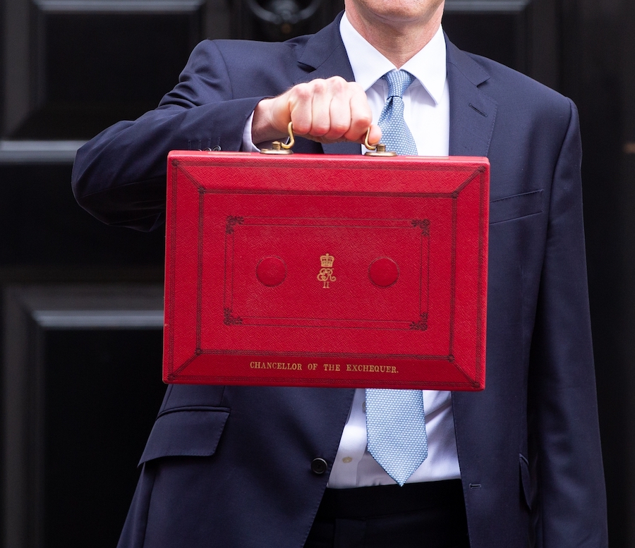 close up of red budget briefcase, held by Jeremy hunt, with black  no 10 door in the background