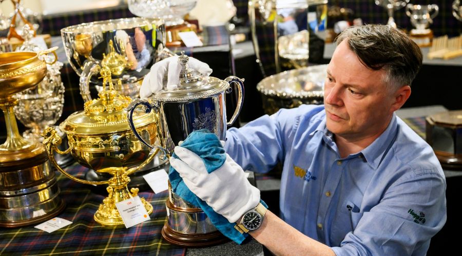 Alain Wright, House & Heritage Officer for RHASS polishing one of over 300 trophies