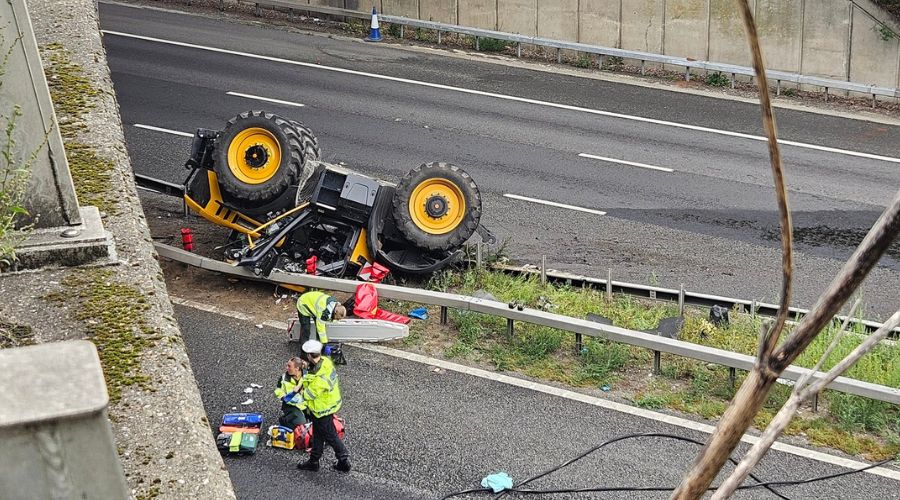 yellow tractor upside down on the central reservation on the M20