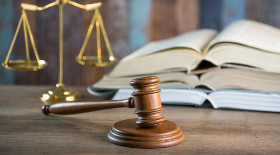 gavel with scale of justice in the background