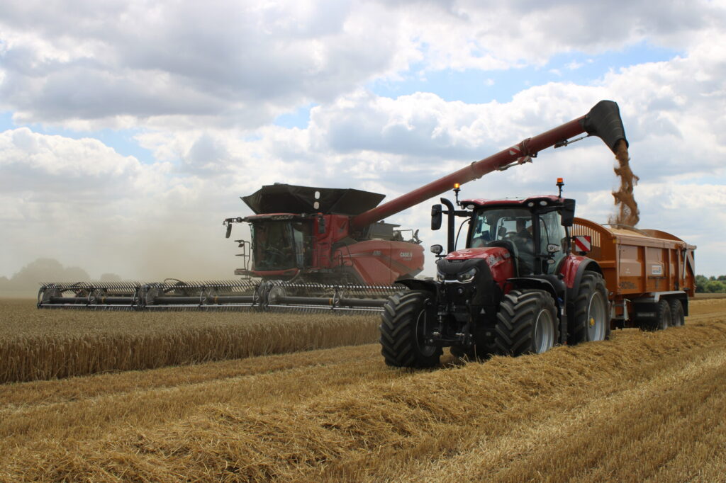 tractor and combine harvesting wheat 