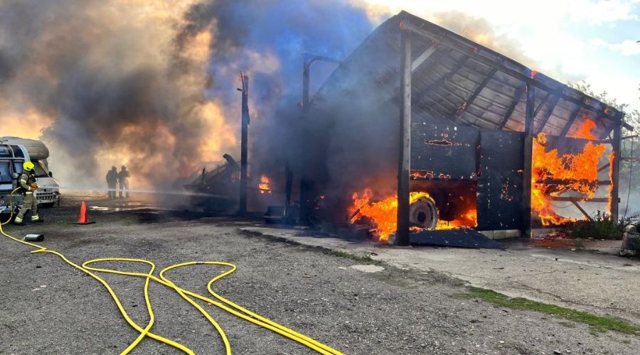 A farm building and several vehicles, including two tractors, were severely damaged in a fire on a farm in Sutton, Suffolk.