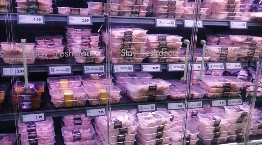 packets of chicken in a fridge in a supermarket