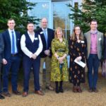 speakers at the larking gowen conference standing outside Hintlesham hall, Suffolk