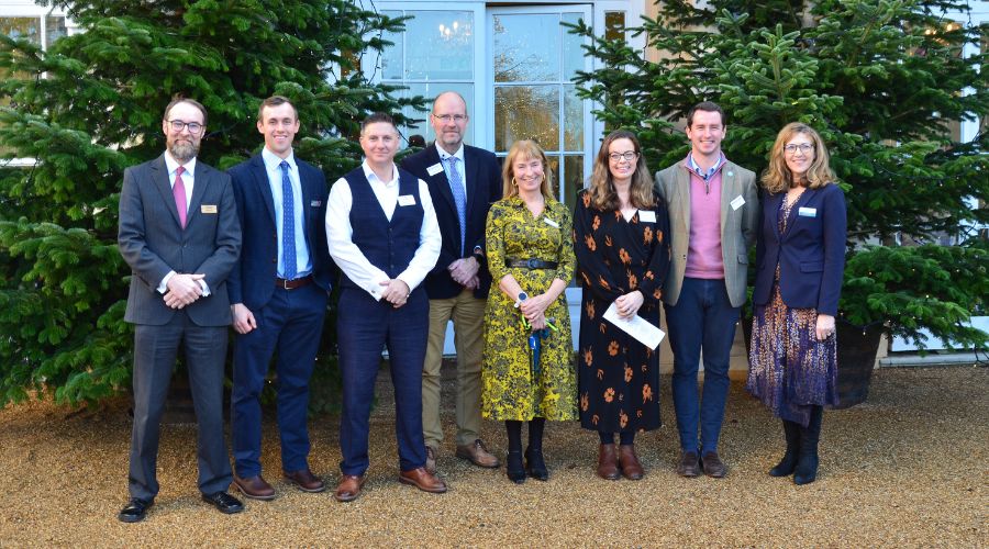 speakers at the larking gowen conference standing outside Hintlesham hall, Suffolk