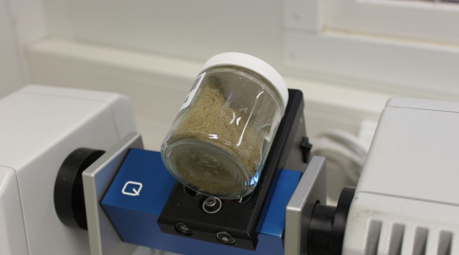 silage sample in a jar on a testing machine