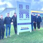hall agri team standing around sign at depot