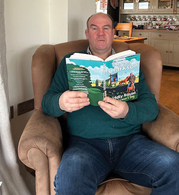 19.	Lucky winner John Thomas from Nr Barry, South Wales, is pictured enjoying his Jeremy Clarkson book, which was donated by Penguin.
