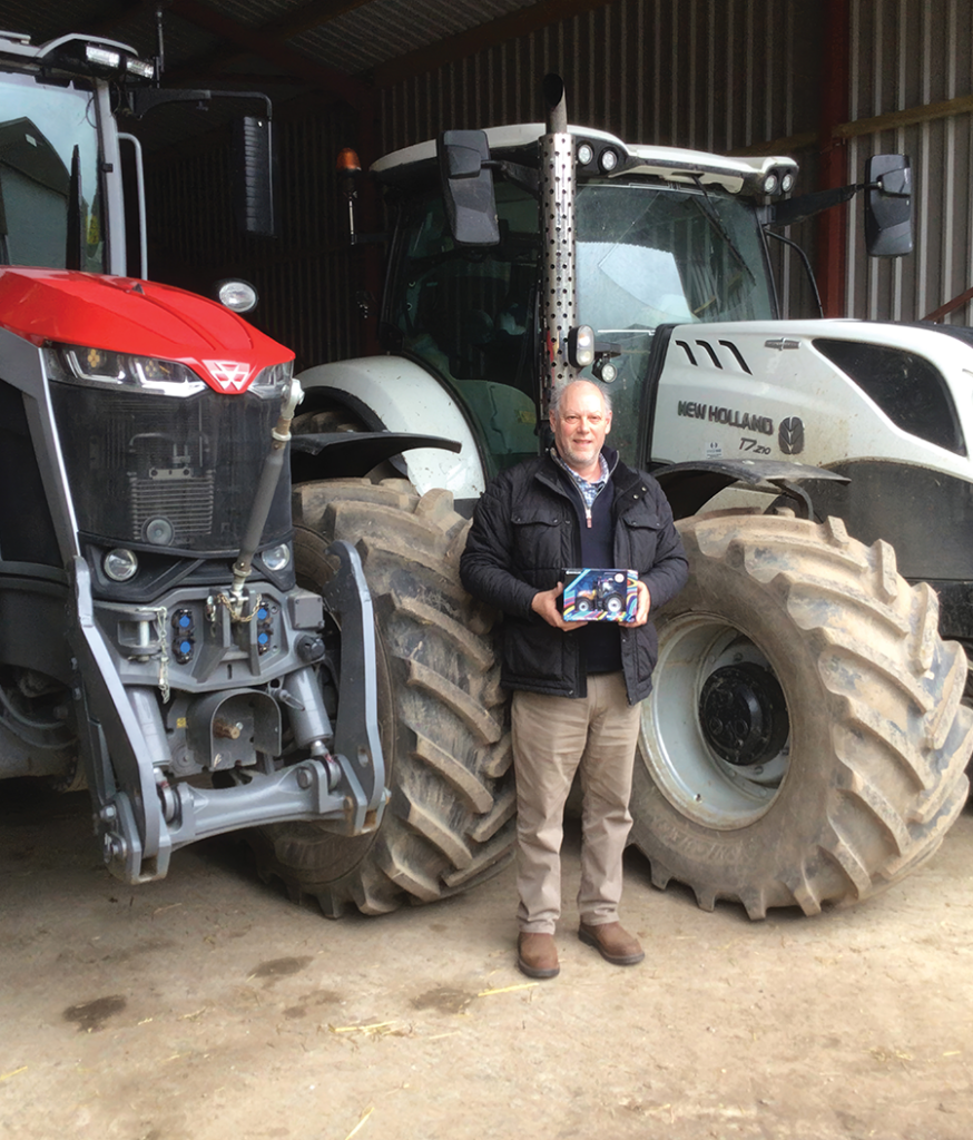 Jeremy Waddup of East Hertfordshire won a limited edition New Holland model, which was kindly donated by Ernest Doe & Sons. Jeremy is pictured with his prize, as well as his own full-sized limited edition New Holland tractor, which was built to celebrate Queen Elizabeth II’s diamond jubilee.